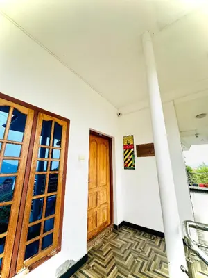a room with a wooden door and a pole at The Haze Land in Ooty