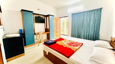 a bedroom with a bed and a sink in it at The Haze Land in Ooty