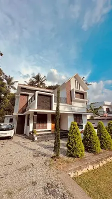 a house with a car parked in front of it at Dolmens Valley Retreat in Marayur in Marayoor