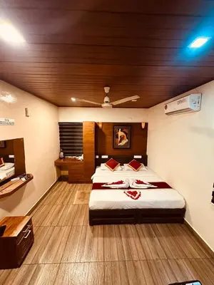 a bedroom with a large bed in a room at Rendezvous Jungle Resort in Sultan Bathery