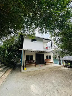 a building with two benches in front of it at Nefs Dreams Villa in Vaduvanchal