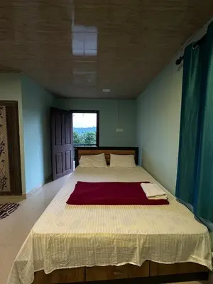 a large bed in a room with a large window at Nefs Dreams Villa in Vaduvanchal