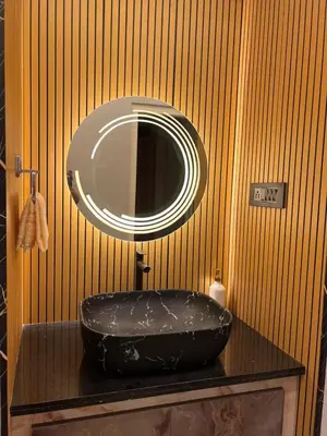 a bathroom with a black sink and a mirror at Kvm RIVER VIEW - 2bhk in Palakkad