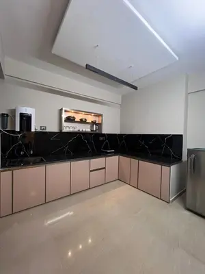 a large kitchen with black counter tops in a room at Kvm RIVER VIEW - 2bhk in Palakkad
