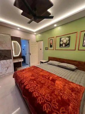 a bedroom with a large bed and a ceiling fan at Kvm RIVER VIEW - 2bhk in Palakkad