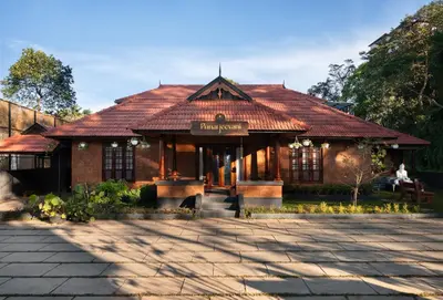 a building with a sign on the front of it at Punarjeevani Ayurvedic Heritage in Vythiri