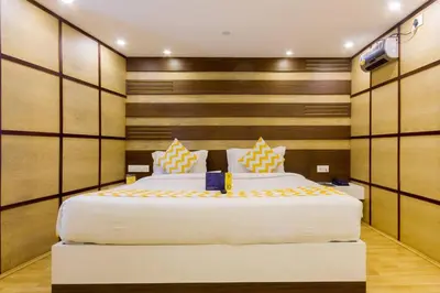 a bedroom with two beds and a tv in it at FabHotel Sholas Residency I - Nr Government Rose Garden in Ooty