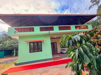 a small house with a green at KOORGI RETREAT- Coorg in Napoklu