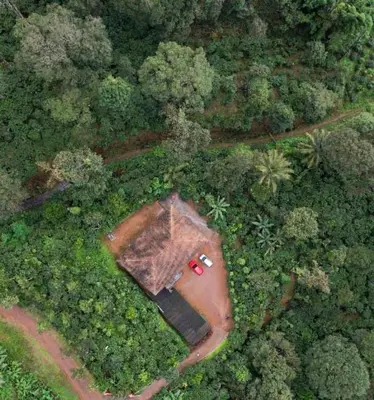 an aerial view of a house in the middle of a forest at KOORGI RETREAT- Coorg in Napoklu