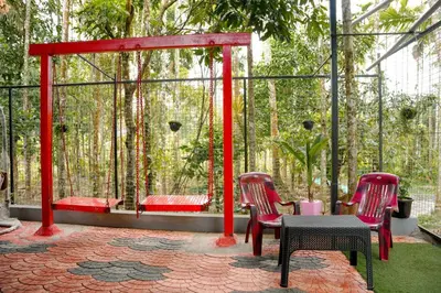 a patio with two chairs and a table and a bench at Dua farms in Sultan Bathery
