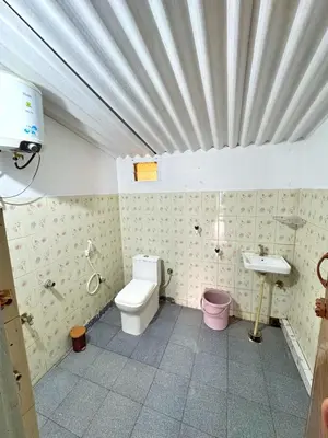 a bathroom with a toilet and a sink at Rafters Retreat Coorg - The Riverside Homestay in Srimangala