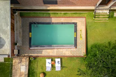 an overhead view of a swimming pool in a yard at amã Stays & Trails - Highland Breeze , Coimbatore in Coimbatore