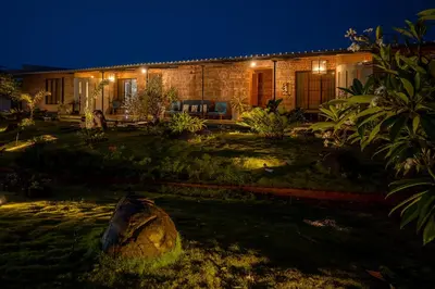 a house with a garden in front of it at night at amã Stays & Trails - Highland Breeze , Coimbatore in Coimbatore