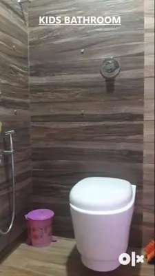 a bathroom with a white toilet and a shower at Charis Villa in Kunnamkulam near Guruvayoor in Kunnamkulam