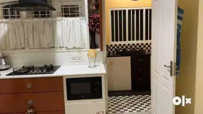 a kitchen with a sink and a stove top oven at Charis Villa in Kunnamkulam near Guruvayoor in Kunnamkulam