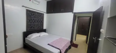 a small bedroom with a bed and a window at Serene Steps Orion in Coimbatore