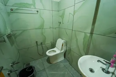 a bathroom with a toilet and a sink at SK Premium Residency in Edakkara