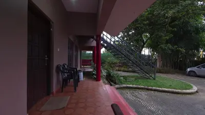 a house with a staircase on the side of a building at Rainbow Homestay Wayanad in Kalpetta