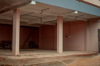 an empty room with columns in a building at Fine Homes in Kalpetta