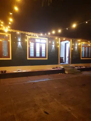 a building with windows and lights on it at night at Edwin and Edrin Service Villa in Wayanad