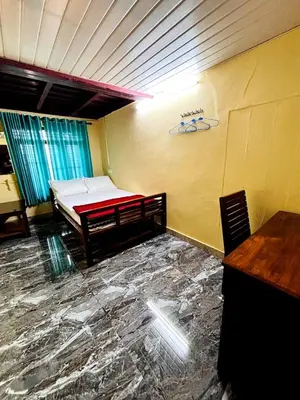 a room with a bed in the corner of a room at Edwin and Edrin Service Villa in Wayanad