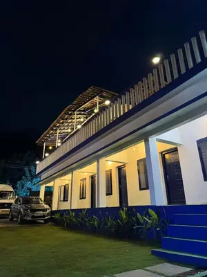 a building with a car parked in front of it at Kadale Boutique Beach Stay in Kannur