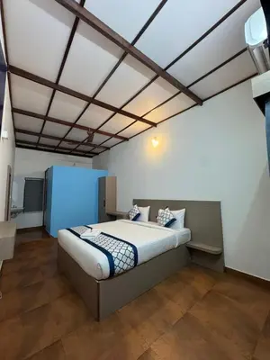 a bedroom with a large bed in a room at Kadale Boutique Beach Stay in Kannur