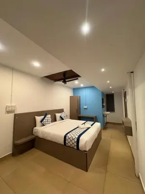 a bedroom with a bed and a blue wall at Kadale Boutique Beach Stay in Kannur