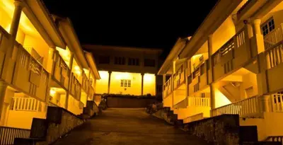 an alley way between two buildings at night at LMS Palve Sugavasam in Ooty