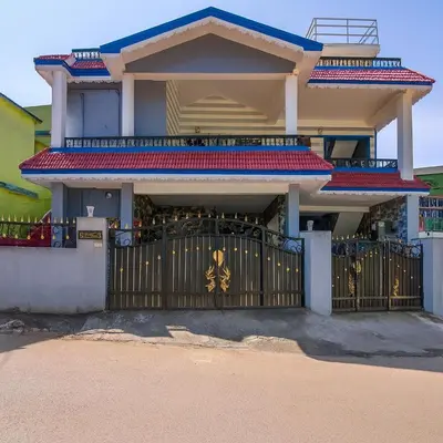 a house with a gate in front of it at LIMRA INN RESIDENCY cottage in Ooty
