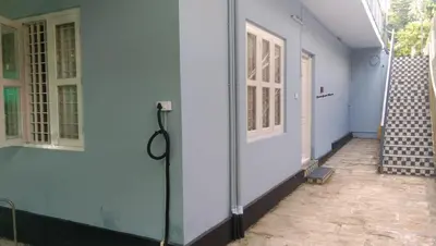 a corridor of a house with a door and stairs at Charis Villa and Guest house 5bed 4bath in kunnamkulam in Kunnamkulam