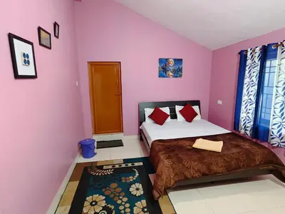 two beds in a room with pink walls at Greenland 2bed room hall villa in Ooty