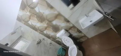 a small bathroom with a toilet and a sink at The Paul Residence