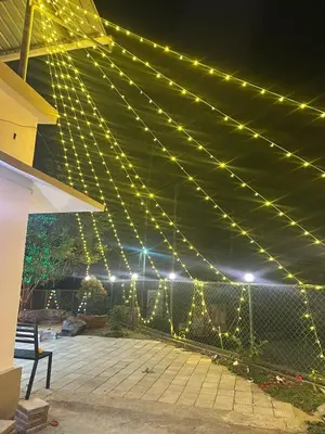a string of lights on a patio at night at SURAAS Homestay Vythiri in Vythiri