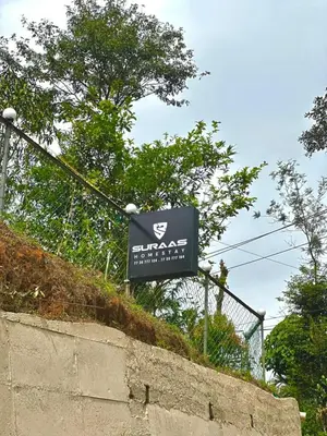 a sign on top of a concrete wall at SURAAS Homestay Vythiri in Vythiri