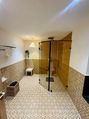 a bathroom with a shower and a toilet at Feliz by slowlane stays in Kotagiri