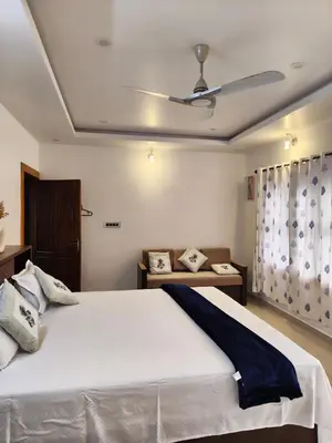 a bedroom with a large white bed with a ceiling at Retreat Rivera where Serenity Meets the River in Green Island
