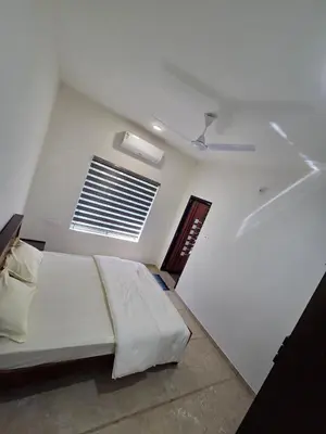 a bedroom with a bed in a room with a window at Satori Stays - KMA Apartments in Kozhikode