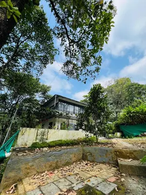a house on top of a concrete wall at Hill valley farm resort in Viripara