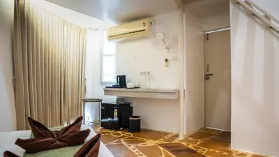 a living room with a heater and a room at Trisara Boutique Stay in Mysore