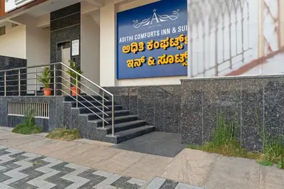 a sign on the side of a building with stairs at Treebo Adithi Comforts Inn And Suites in Mysore