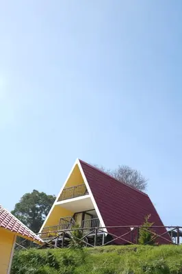 a house with a red roof at Cloudy Nandy Hills Poombarai in Kūkkāl