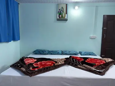 a bed with two blankets on top of it at BN HOMESTAY be nature in Devikolam
