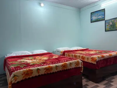 two beds in a room with two beds sidx sidx sidx at BN HOMESTAY be nature in Devikolam