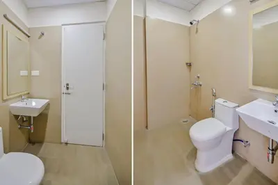 a bathroom with a toilet and a sink and a shower at capital o hotel paradise international in Coimbatore