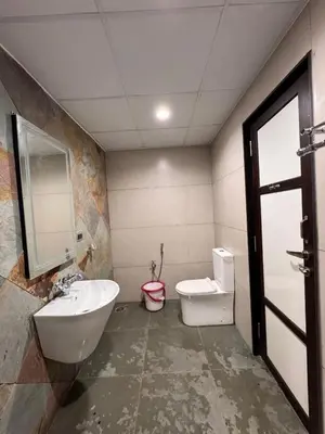 a bathroom with a sink and a tub and a toilet at Chettinadu Pool Villa in Pollāchi