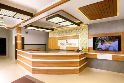 a lobby of a restaurant with a reception counter at MK Residency Calicut near Baby Memorial Hospital in Kozhikode