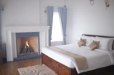 a bedroom with a bed and a fireplace at Memories at The Blue Mountains in Kotagiri