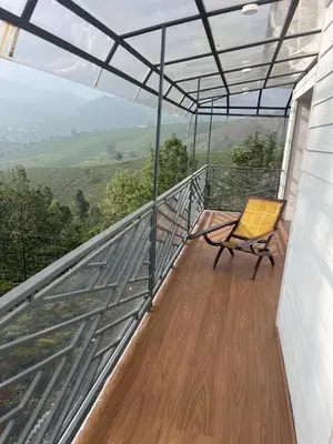 a chair sitting on the balcony of a house at Memories at The Blue Mountains in Kotagiri