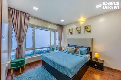 a bedroom with a bed and a large window at Mistydawn Villas By Sunset Valley by VEO - Part of StayVista in Ooty